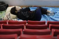 A family member of a missing passenger onboard capsized South Korean ferry Sewol rests as she waits for news from rescue and salvage teams at a makeshift accommodation at a gymnasium in the port city of Jindo April 22, 2014. REUTERS/Issei Kato