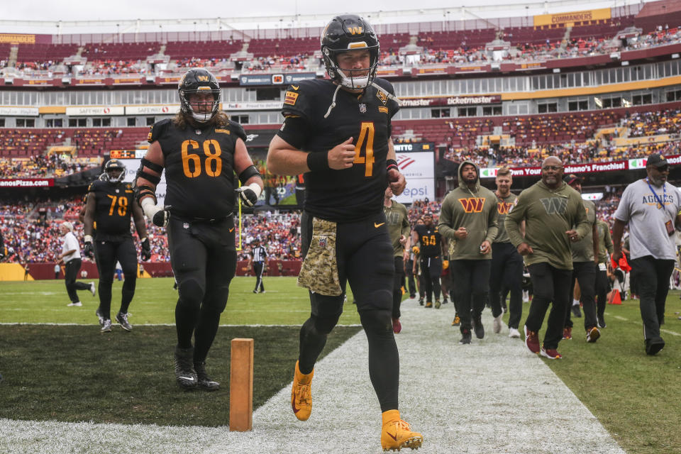 Washington Commanders quarterback Taylor Heinicke (4) goes to the locker room after the first half of a NFL football game between the Washington Commanders and the Minnesota Vikings on Sunday, Nov. 6, 2022 in Landover, Md. (Shaban Athuman/Richmond Times-Dispatch via AP)