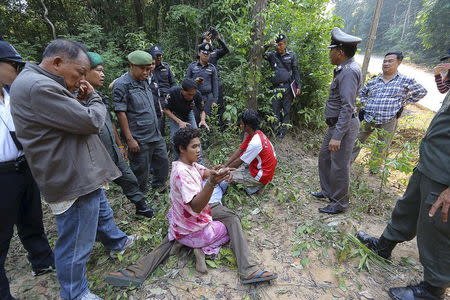 A Cambodian fisherman, who is a suspect, (C), points during a crime re-enactment at Koh Kood island near Thailand's maritime border with Cambodia, February 29, 2016. REUTERS/Dailynews