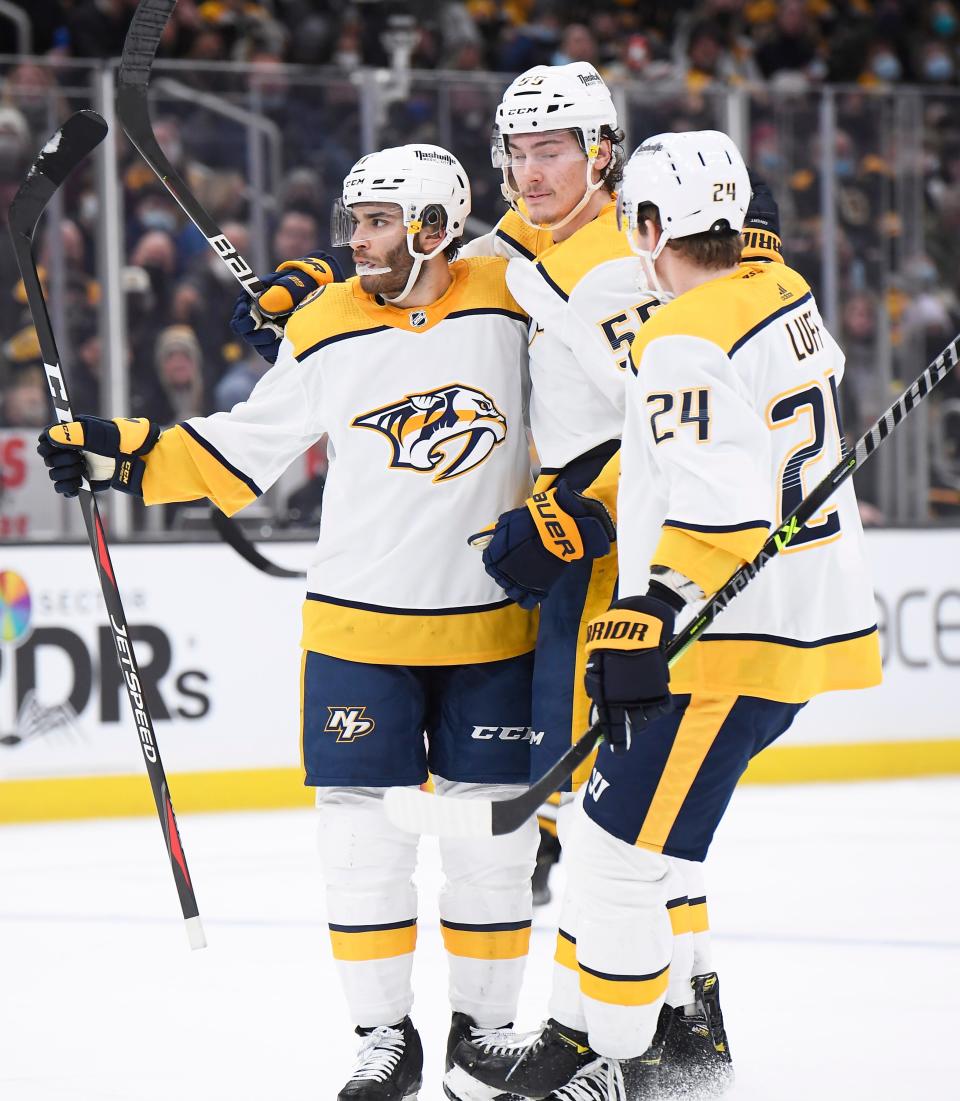 Jan 15, 2022; Boston, Massachusetts, USA;  Nashville Predators center Luke Kunin (11) is congratulated by defenseman Philippe Myers (55) and right wing Matt Luff (24) after scoring a goal during the second period against the Boston Bruins at TD Garden.