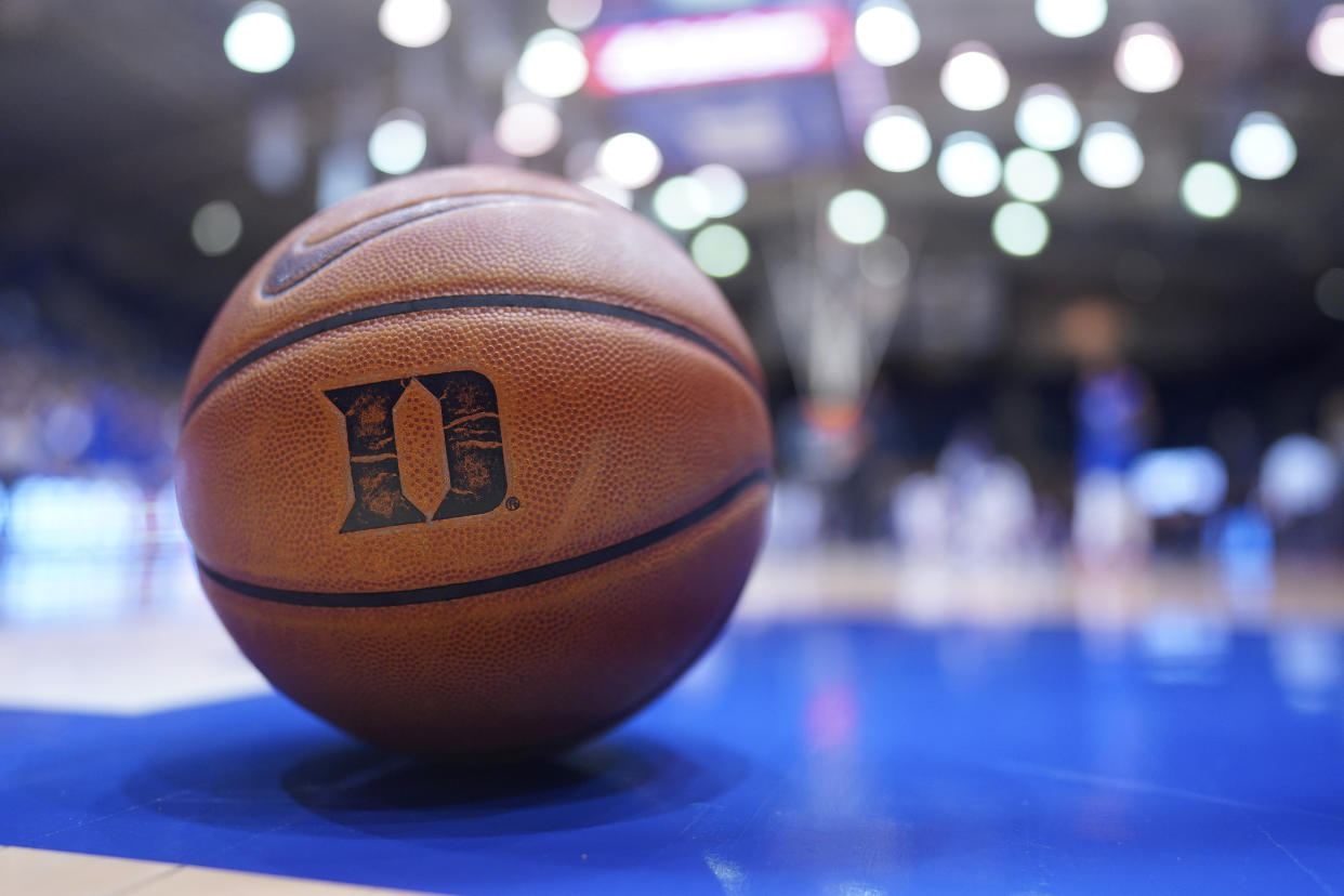 Duke basketball sits on court.