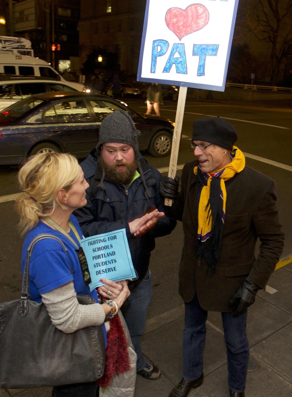 Teachers from neighboring districts, Brian Haliski (R) and Joe Vermeire (C) show support for Portland teachers after they voted to strike in Portland, Oregon February 5, 2014. (REUTERS/Steve Dipaola)