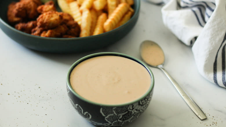 orange sauce in a green bowl