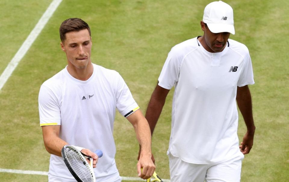 Briton Joe Salisbury and his doubles partner Rajeev Ram argue Hawkeye's decision - GETTY IMAGES