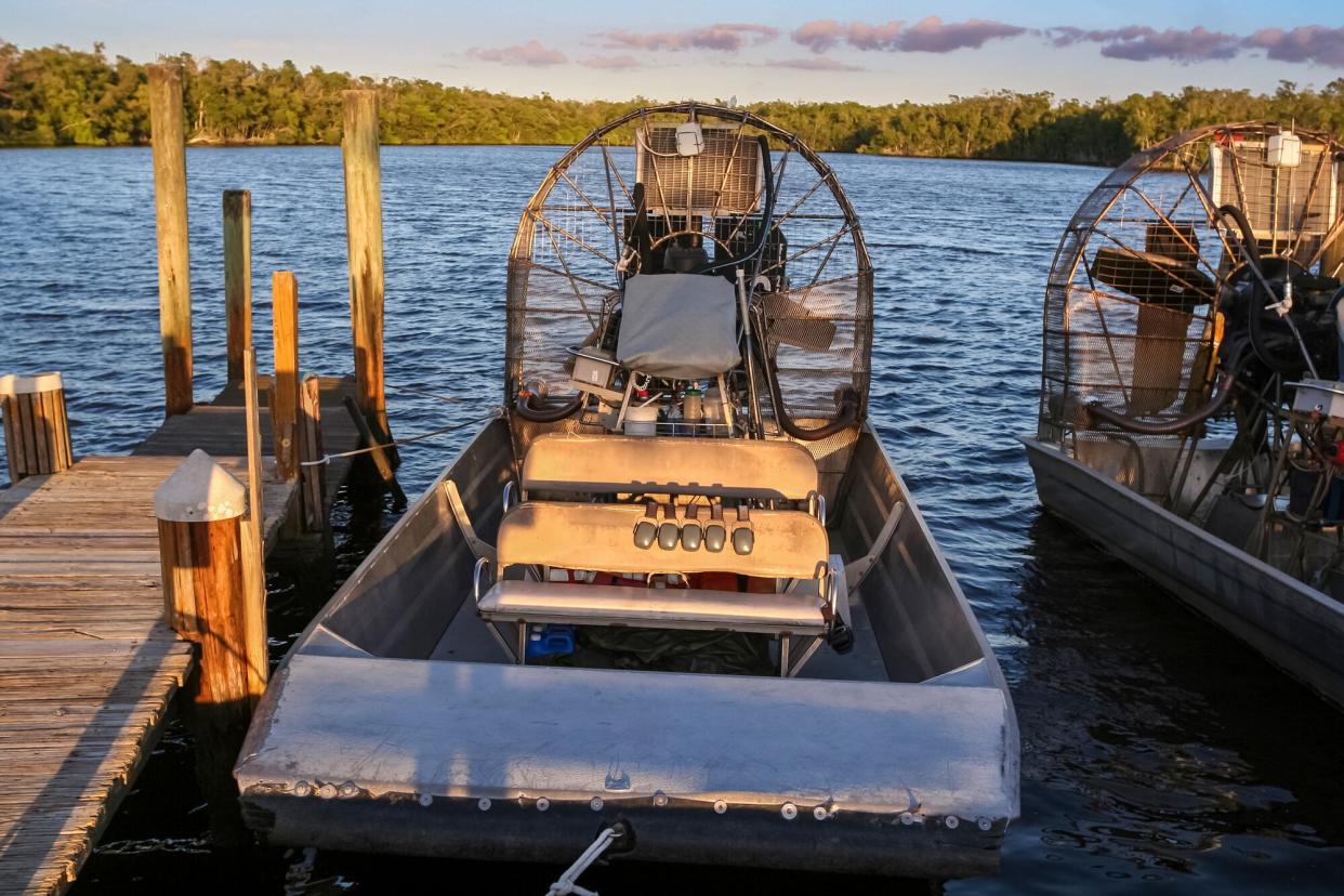 two Air Boat with propeller on a body of water in the Florida Everglades.