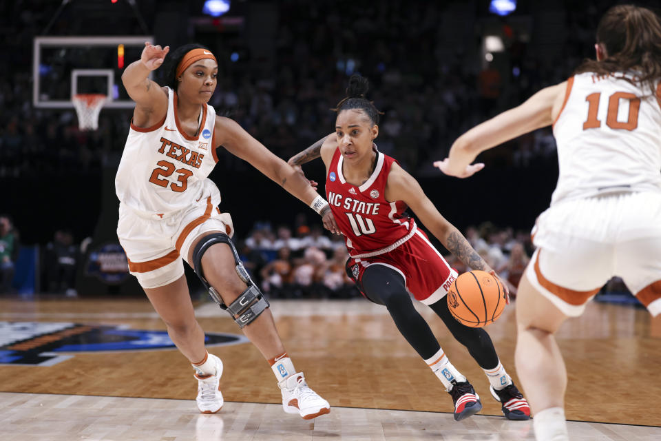 North Carolina State guard Aziaha James (10) drives to the basket as Texas forward Aaliyah Moore defends during the second half of an Elite Eight college basketball game in the women's NCAA Tournament, Sunday, March 31, 2024, in Portland, Ore. (AP Photo/Howard Lao)
