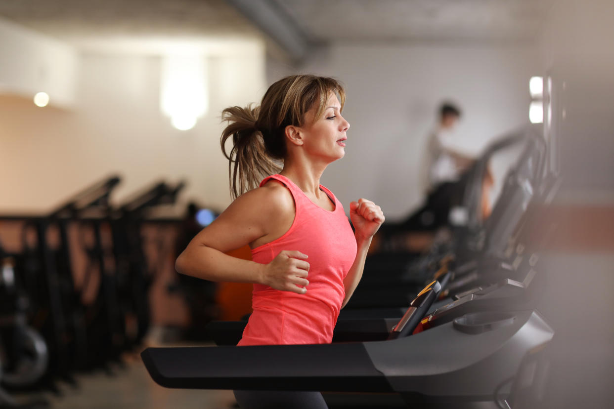 Woman running on treadmill at gym. (Getty Images)