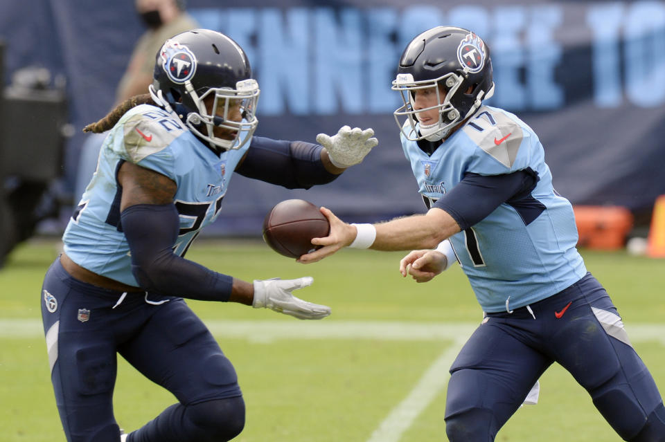 Tennessee Titans quarterback Ryan Tannehill (17) hands the ball off to running back Derrick Henry (22) in the first half of an NFL football game against the Pittsburgh Steelers Sunday, Oct. 25, 2020, in Nashville, Tenn. (AP Photo/Mark Zaleski)