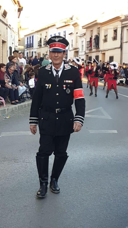 A man disguised as a nazi officer walks during a carnival parade in Campo De Criptana