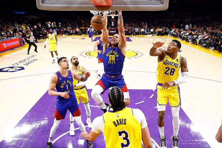 Aaron Gordon, el principal anotador de Denver Nuggets, queda colgado del aro ante la mirada de los rivales de Los Angeles Lakers