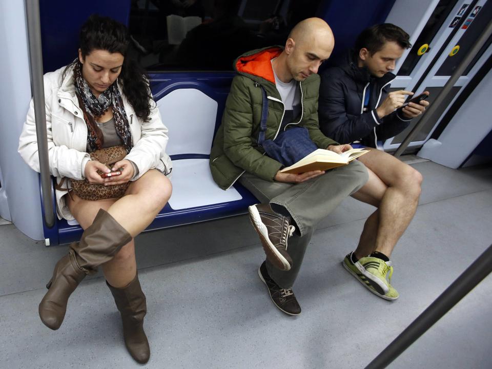 Passengers without their pants sit inside a train during the "No Pants Subway Ride" event at a subway station in Madrid