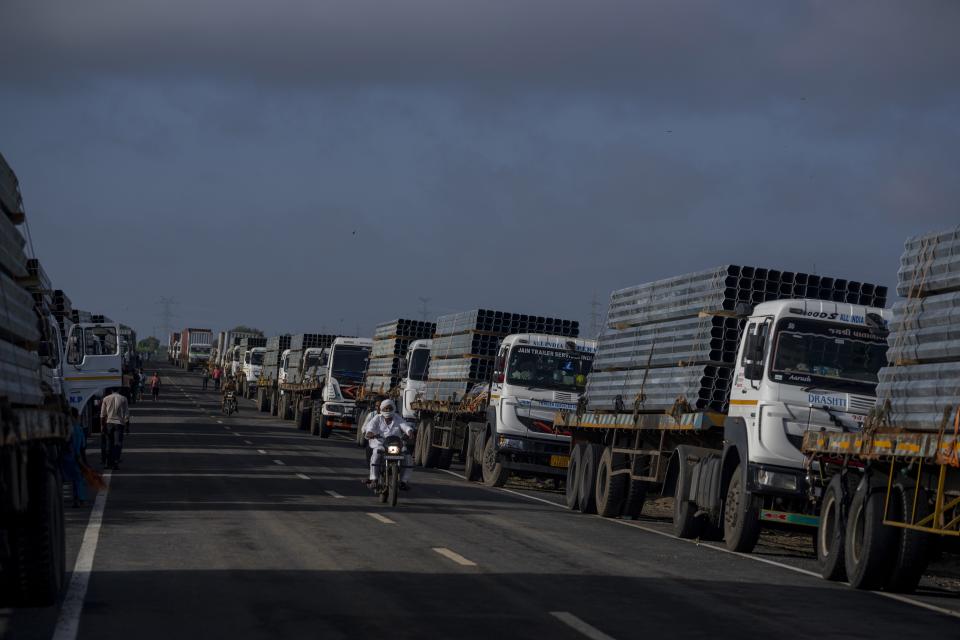 Trucks carry aluminium alloy frames to Adani Green Energy Limited's Renewable Energy Park near Khavda, Bhuj district near the India-Pakistan border in the western state of Gujarat, India, Thursday, Sept. 21, 2023. India is developing a 30 gigawatt hybrid — wind and solar — renewable energy project on one of the largest salt deserts in the world. (AP Photo/Rafiq Maqbool)
