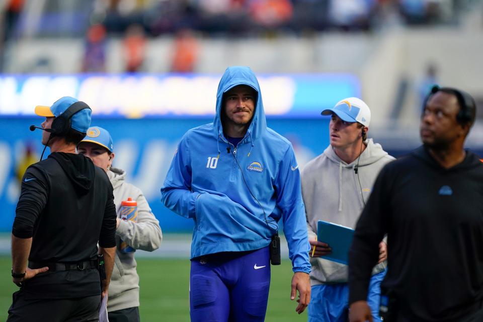 Chargers quarterback Justin Herbert walks on the sidelines after an injury with his hand in his hoodie pocket during the Week 14 game against the Broncos on Dec. 10, 2023.
