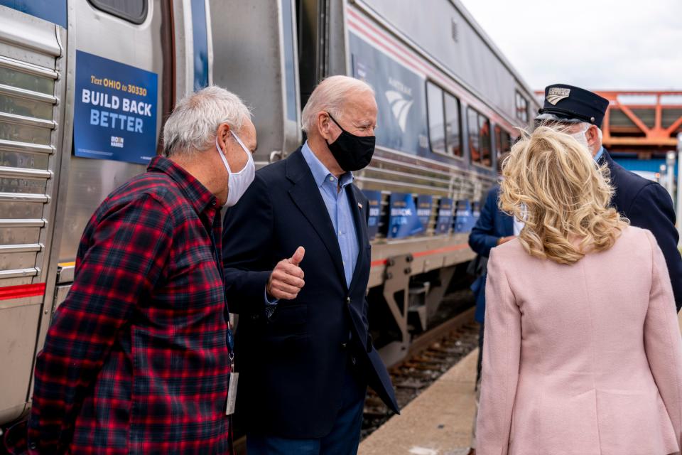 Then Democratic presidential nominee Joe Biden gives a thumbs up after speaking to supporters before boarding his train with his wife Jill Biden, right, at Amtrak's Cleveland Lakefront train station on Sept. 30, 2020.