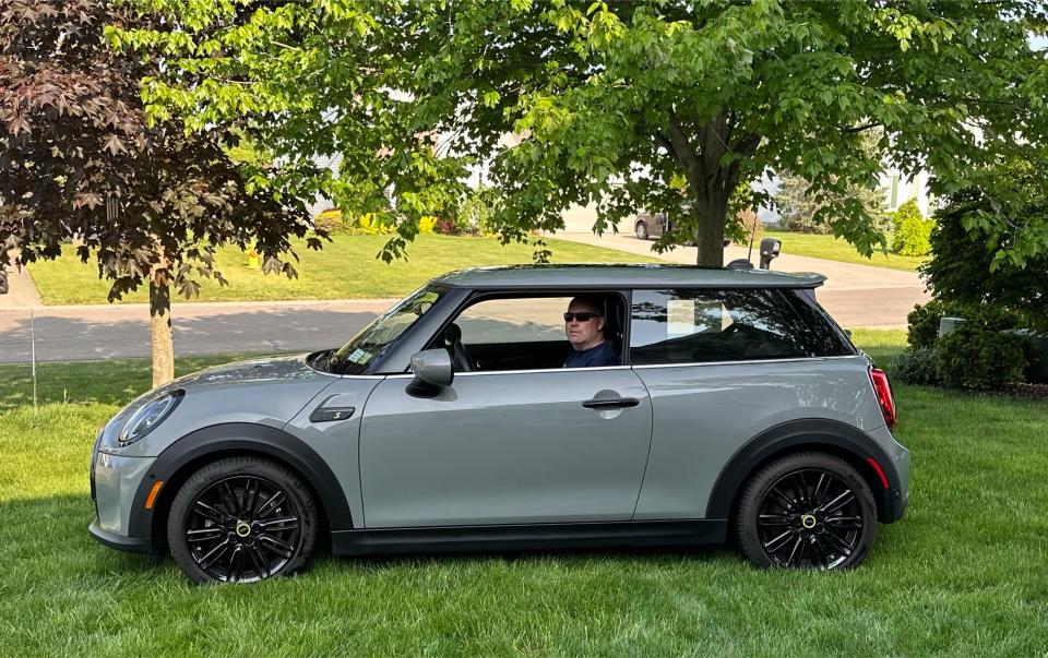 Gerry Goris, of Buffalo, New York, sits in his new 2022 Mini Cooper SE electric vehicle in Moonwalk Grey. Goris traded in his 2020 EV for the new one last November.