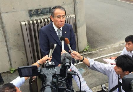 Tsuguo Hirota, 68, the lawyer coordinating a lawsuit on Tokyo Electric, speaks to media after filing a lawsuit claiming unpaid wages on behalf of workers, in front of a court in Iwaki, Fukushima prefecture September 3, 2014. REUTERS/Kevin Krolicki