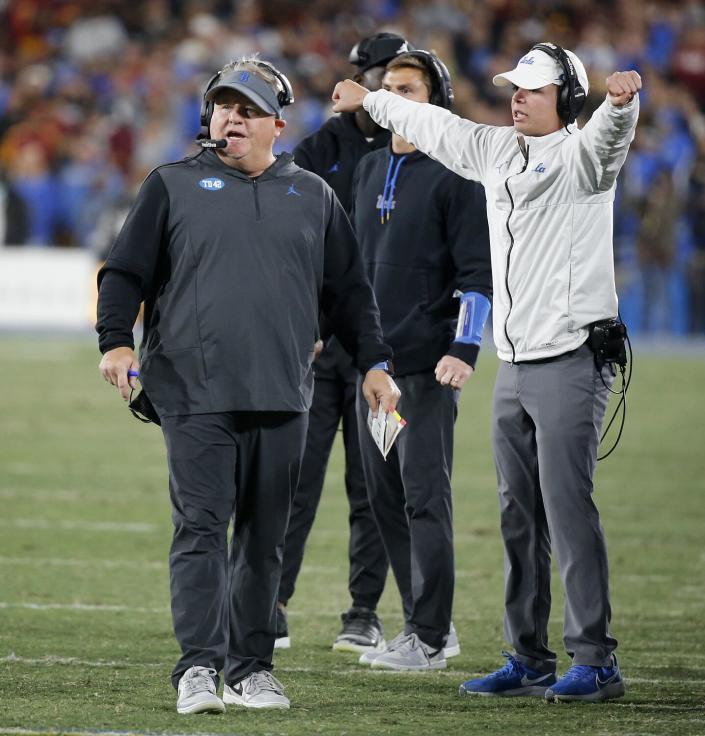 UCLA coach Chip Kelly, left, walks on the sideline during the second half of Saturday's loss to USC at the Rose Bowl.