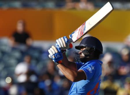 India's batsman Rohit Sharma hits over the boundary for six runs during his Cricket World Cup match against United Arab Emirates in Perth, February 28, 2015. REUTERS/David Gray