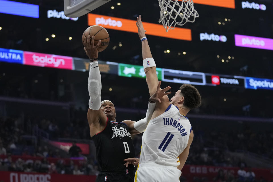 Los Angeles Clippers guard Russell Westbrook (0) shoots against Golden State Warriors guard Klay Thompson (11) during the first half of an NBA basketball game in Los Angeles, Saturday, Dec. 2, 2023. (AP Photo/Ashley Landis)