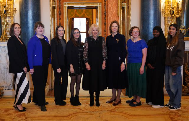 <p>Yui Mok-WPA Pool/Getty </p> Queen Camilla (center) poses with Changemakers and SafeLives executives during a discussion at Buckingham Palace on April 16, 2024.