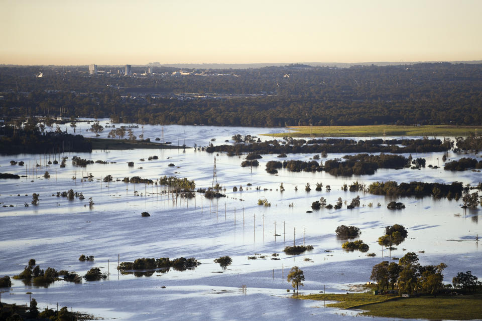 Floodwater covers large areas northwest of Sydney, Australia, Wednesday, March 24, 2021. Some 18,000 residents of Australia's most populous state have fled their homes since last week, with warnings the flood cleanup could stretch into April. (Lukas Coch/Pool Photo via AP)