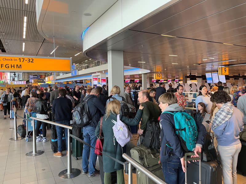 FILE PHOTO: Long lines of waiting travellers at Amsterdam Schiphol Airport due to unannounced strike