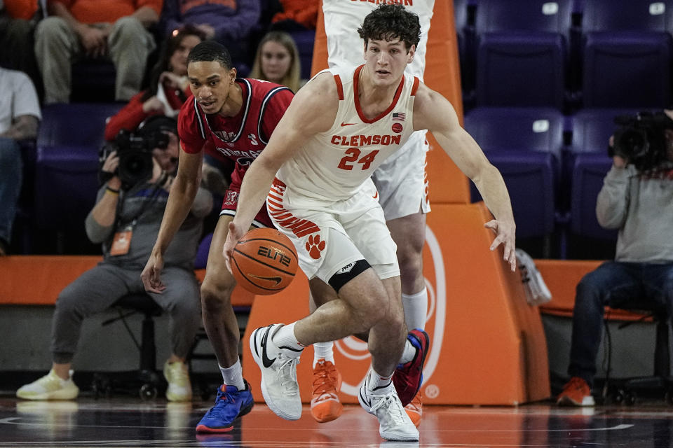 Clemson center PJ Hall (24) steals the ball from Radford center D'Auntray Pierce during the first half of an NCAA college basketball game, Friday, Dec. 29, 2023, in Clemson. (AP Photo/Mike Stewart)