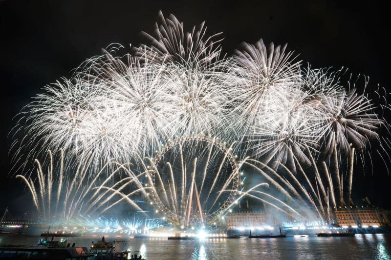 Fireworks light up the sky over the London Eye in central London during the New Year celebrations. Victoria Jones/PA Wire/dpa