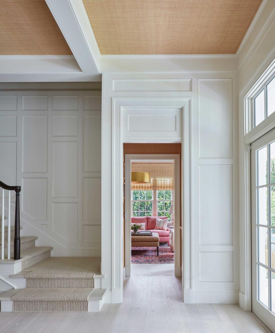 an entryway with grasscloth wallpaper