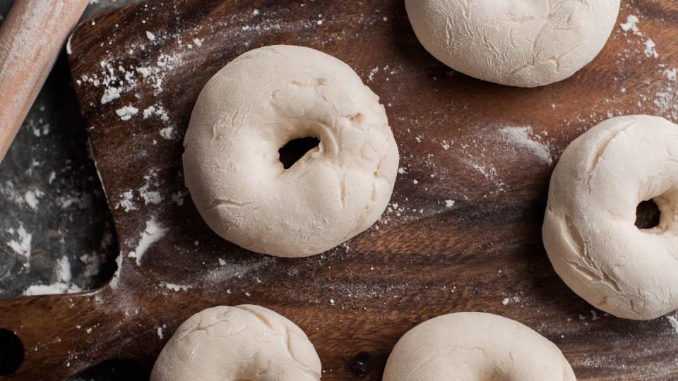 still life of raw bagel on a cutting board