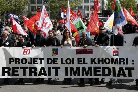 French labour union workers and students attend a demonstration against the French labour law proposal in Lyon, France, as part of a nationwide labor reform protests and strikes, April 28, 2016. The slogan reads "Withdrawal of El Khomri law". REUTERS/Robert Pratta
