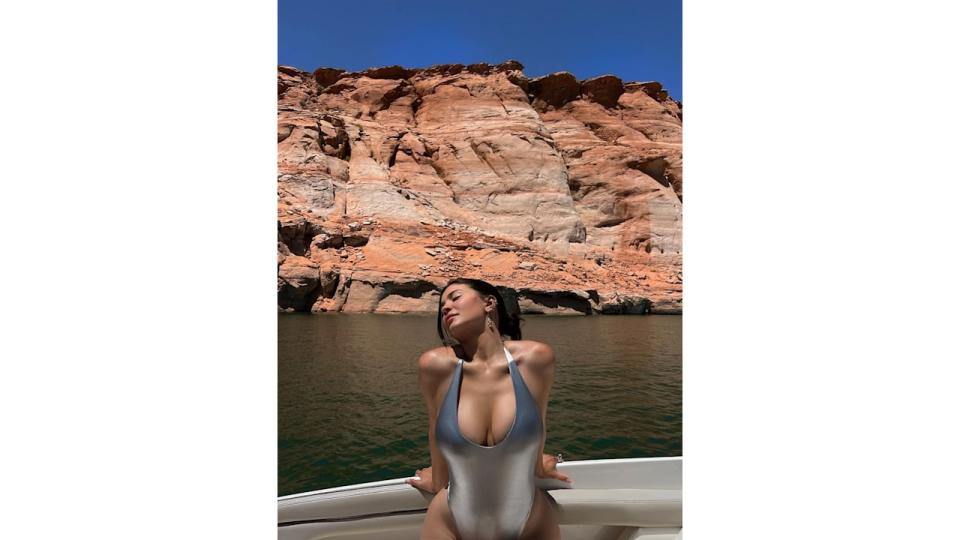 Kylie Jenner poses in a silver metallic swimsuit