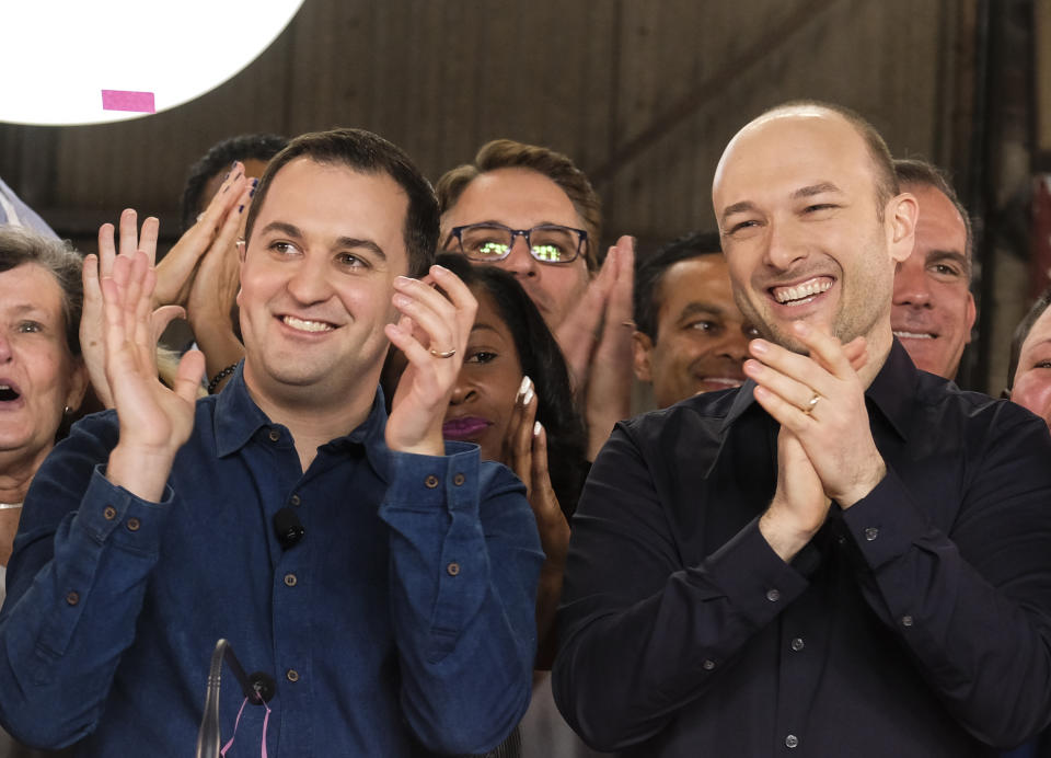 Lyft co-founders John Zimmer, left, and Logan Green cheer as they as they ring a ceremonial opening bell in Los Angeles, Friday, March 29, 2019. On Friday the San Francisco company's stock will begin trading on the Nasdaq exchange under the ticker symbol "LYFT." (AP Photo/Ringo H.W. Chiu)