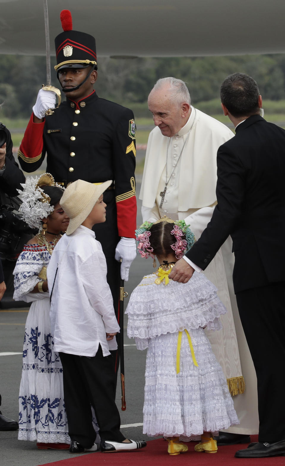 Pope Francis greets children as he arrives to Tocumen international airport to attend World Youth Day events in Panama City, Wednesday, Jan. 23, 2019. Pope Francis will be in Panama Jan. 23-27. (AP Photo/Alessandra Tarantino)