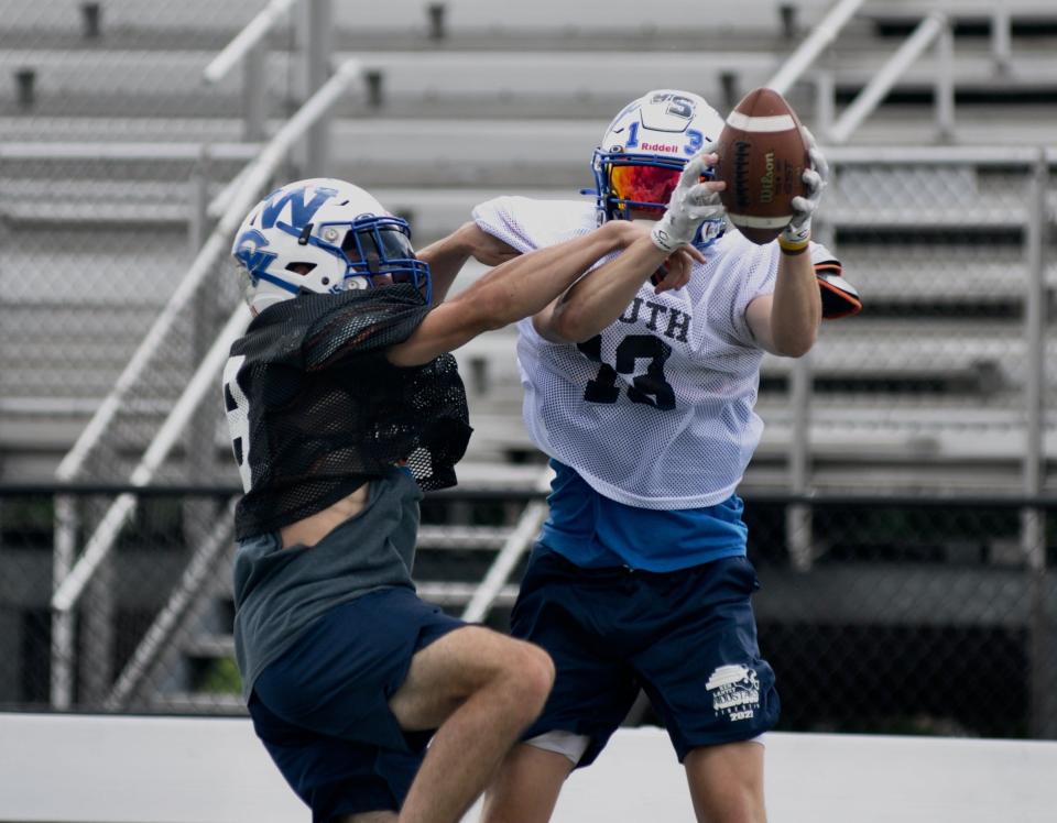 South Team wide receiver Keith Charney, right, hauls in a catch with being tightly defended by South defensive back Nick Dom during Ken Lantzy Finest 40 All-Star Classic practice, Monday, at Richland High School.