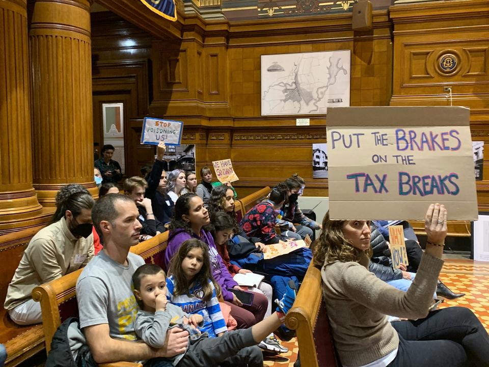 Opponents of the Providence City Council Finance Committee's votes on Monday night to approve a new 30-year tax deal and lease extension with ProvPort wait to testify in the council chambers.