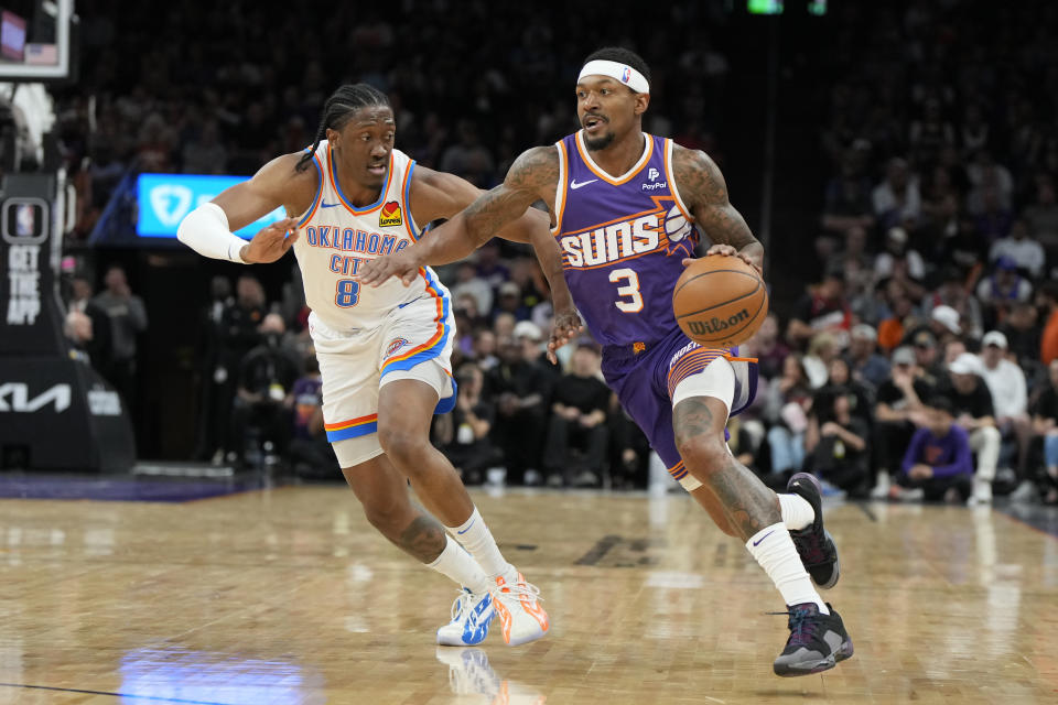 Phoenix Suns guard Bradley Beal (3) drives past Oklahoma City Thunder forward Jalen Williams (8) during the second half of an NBA basketball game, Sunday, March 3, 2024, in Phoenix. (AP Photo/Rick Scuteri)