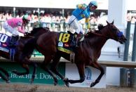 uMay 2, 2015; Louisville, KY, USA; Victor Espinoza aboard American Pharoah celebrates winning the 141st Kentucky Derby at Churchill Downs. Mandatory Credit: Peter Casey-USA TODAY Sports