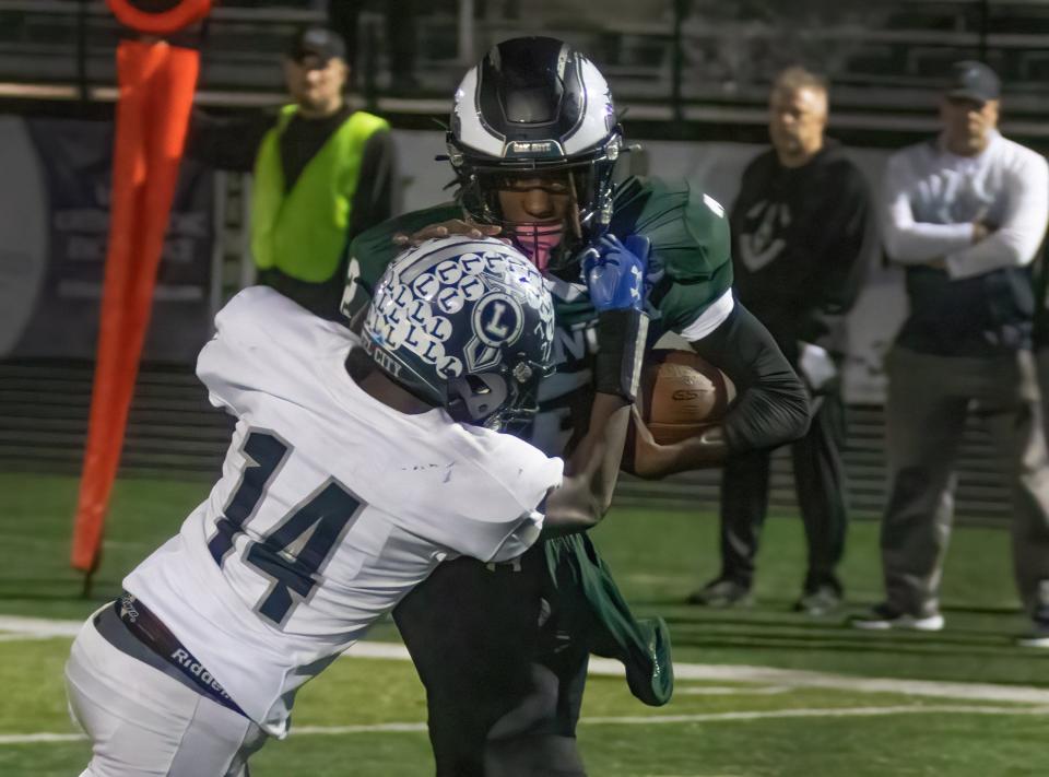 GlenOak’s Adrion Burt scores a touchdown through Lorain’s Joseph Gains to give GlenOak a 16-7 lead with 1:46 remaining in the fourth quarter, Friday, Oct. 27, 2023.