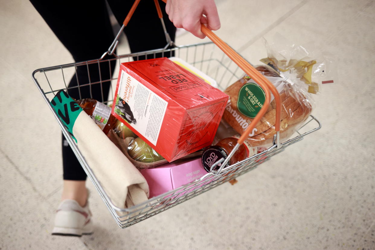 inflation  A person carries a shopping basket at a Sainsbury's store, amid the coronavirus disease (COVID-19) outbreak, in London, Britain December 21, 2020. REUTERS/Hannah McKay