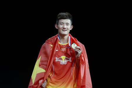 China's Chen Long celebrates with his medal after winning the men's singles final against Malaysia's Lee Chong Wei at the Badminton World Championship in Copenhagen August 31, 2014. REUTERS/Liselotte Sabroe/Scanpix Denmark