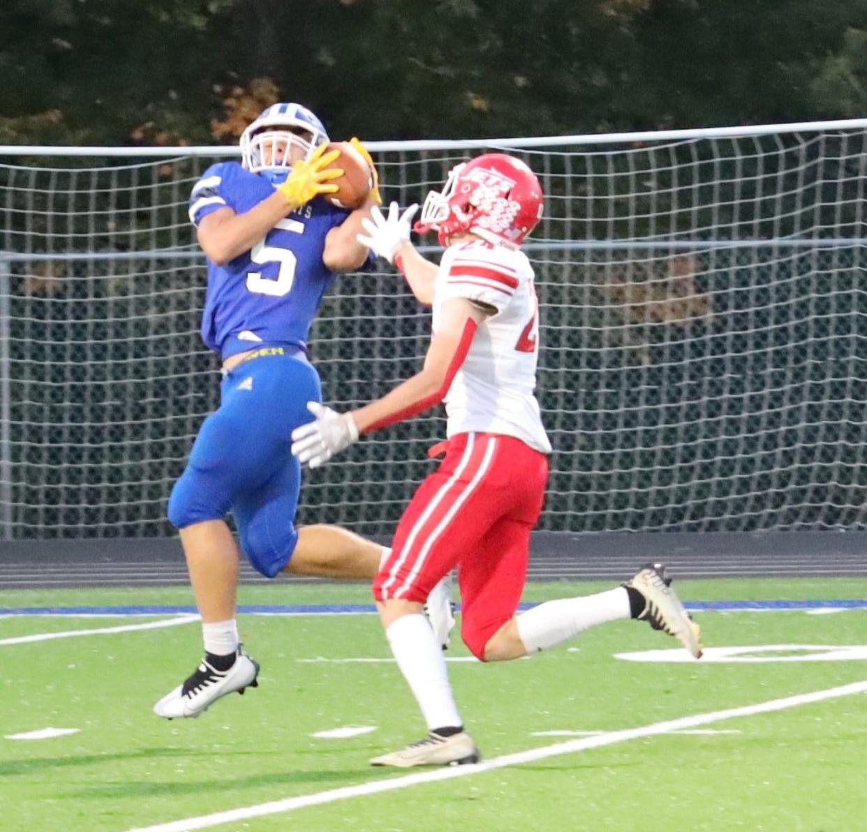 Cambridge's Devin Ogle (5) catches the ball during the football game against Union Local at McFarland Stadium Friday night.