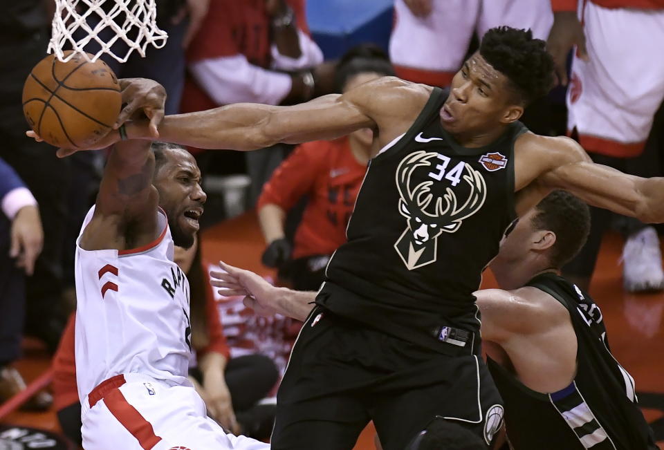 Milwaukee Bucks forward Giannis Antetokounmpo (34) blocks a dunk attempt by Toronto Raptors forward Kawhi Leonard, left, during the second half of Game 6 of the NBA basketball playoffs Eastern Conference finals Saturday, May 25, 2019, in Toronto. (Frank Gunn/The Canadian Press via AP)