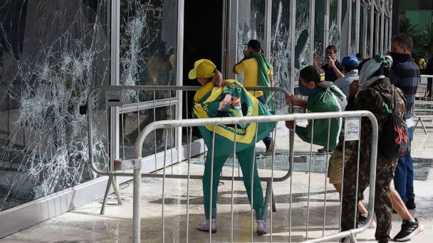 PHOTO: Supporters of Brazilian former President Jair Bolsonaro destroy a window of the the plenary of the Supreme Court in Brasilia, Jan. 8, 2023. (Ton Molina/AFP via Getty Images)