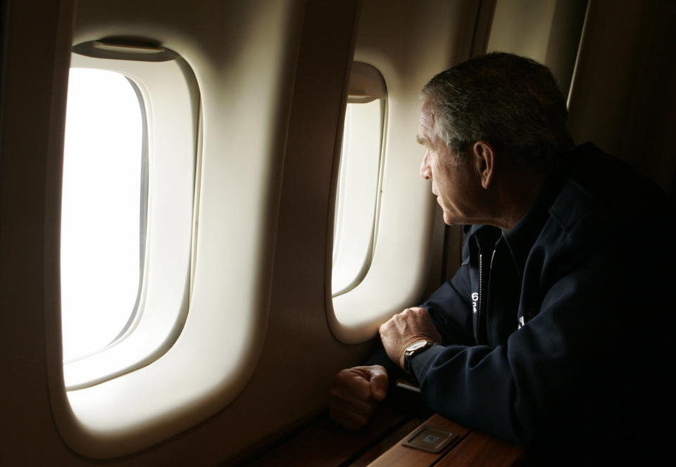 FILE - In this Aug, 31, 2005 file photo, President Bush looks out the window of Air Force One inspecting damage from Hurricane Katrina while flying over New Orleans en route back to the White House. (AP Photo/Susan Walsh)