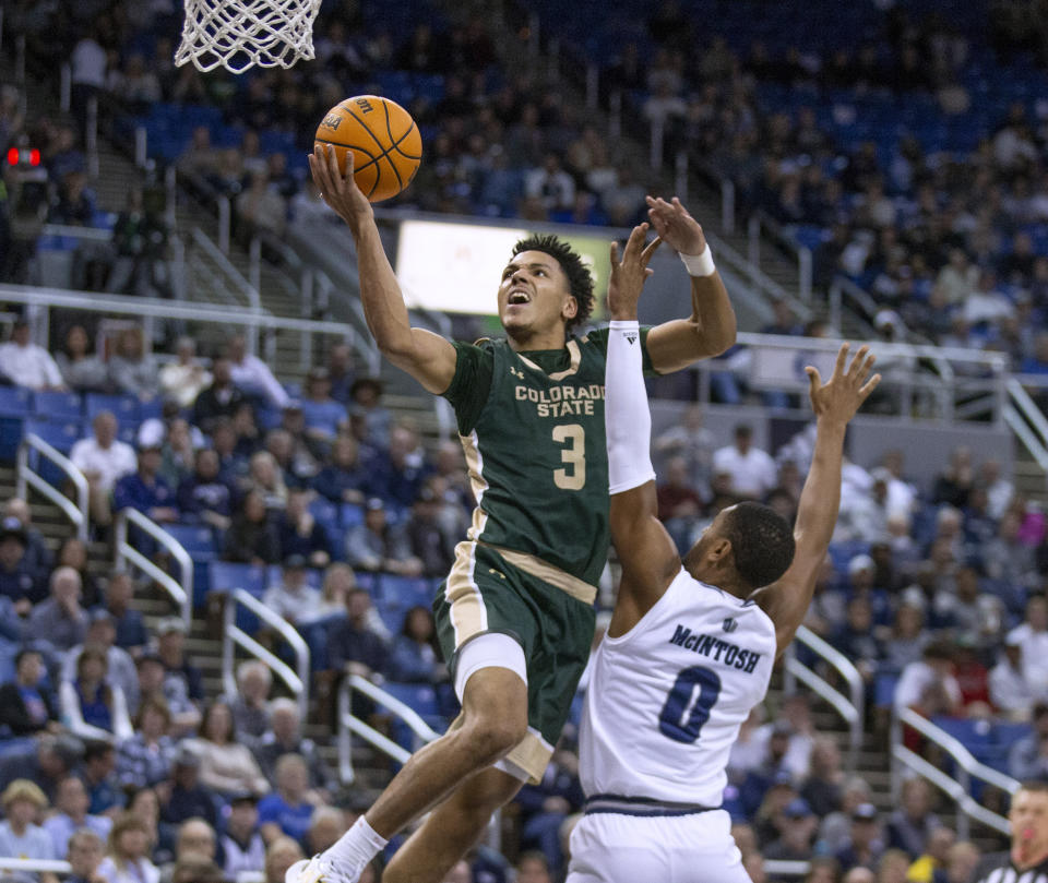 Colorado State guard Josiah Strong (3) shoots over Nevada guard Hunter McIntosh (0) during the second half of an NCAA college basketball game Wednesday, Jan. 24, 2024, in Reno, Nev. (AP Photo/Tom R. Smedes)