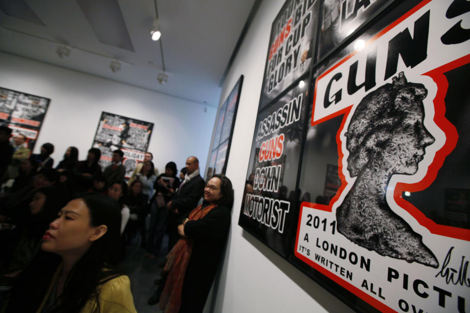 FILE - In this March 1, 2012 file photo, visitors attend the press conference of British artists Gilbert & George in the White Cube gallery in Hong Kong. In the past decade, Hong Kong's art scene has mushroomed thanks to soaring numbers of wealthy mainland Chinese and other Asians who have developed a taste for collecting. Big names like London's White Cube and Larry Gagosian of the U.S. have opened local outposts of their art dealing empires while numerous lesser-known galleries have also sprouted up over the past decade. (AP Photo/Kin Cheung, FILE)