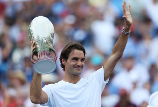 Roger Federer of Switzerland celebrates with the trophy after defeating Novak Djokovic of Serbia during the final on day nine of the Western & Southern Open at Lindner Family Tennis Center in Mason, Ohio. Federer won his sixth title of the season as he beat second-seeded Djokovic 6-0, 7-6 (9/7)