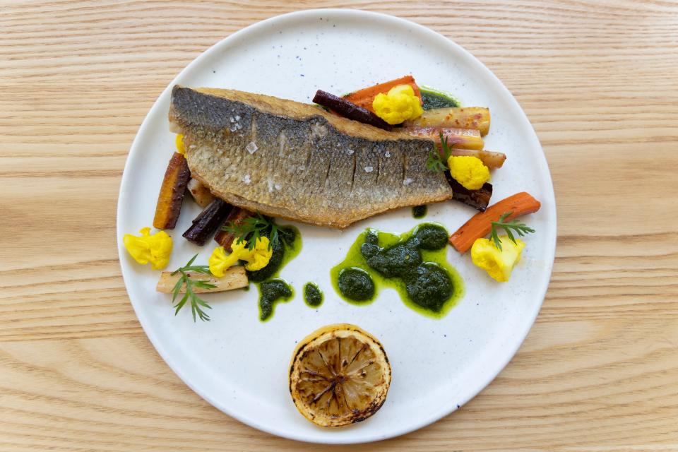 A view of Salazar Restaurant and Bar's crispy skin branzino with harissa roasted carrots, chermoula sauce, and turmeric-pickled cauliflower. Salazar is participating in Greater Cincinnati Restaurant Week.