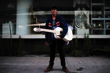 Migrant musician Cristian Martinez from El Salvador, poses for a photo during his journey towards the United States, in Mexico City, Mexico, January 31, 2019. REUTERS/Alexandre Meneghini